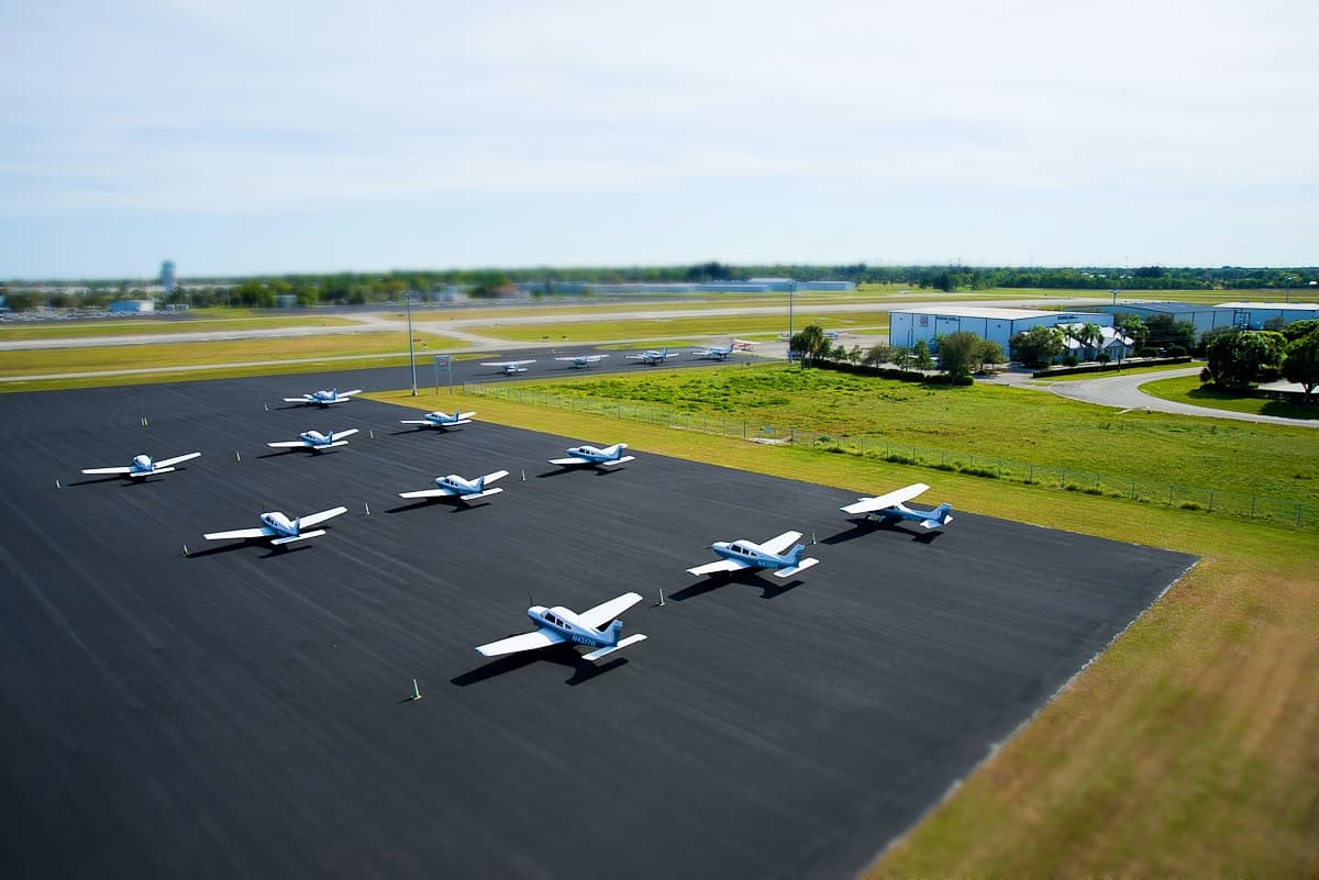 Aerial view of airplanes lined up on the ground