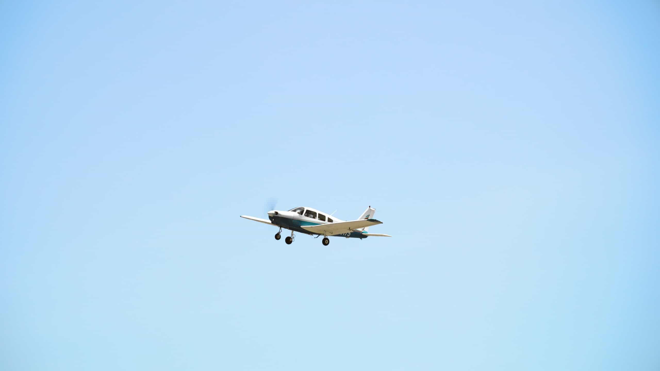 A Paris Air small airplane against a clear blue sky