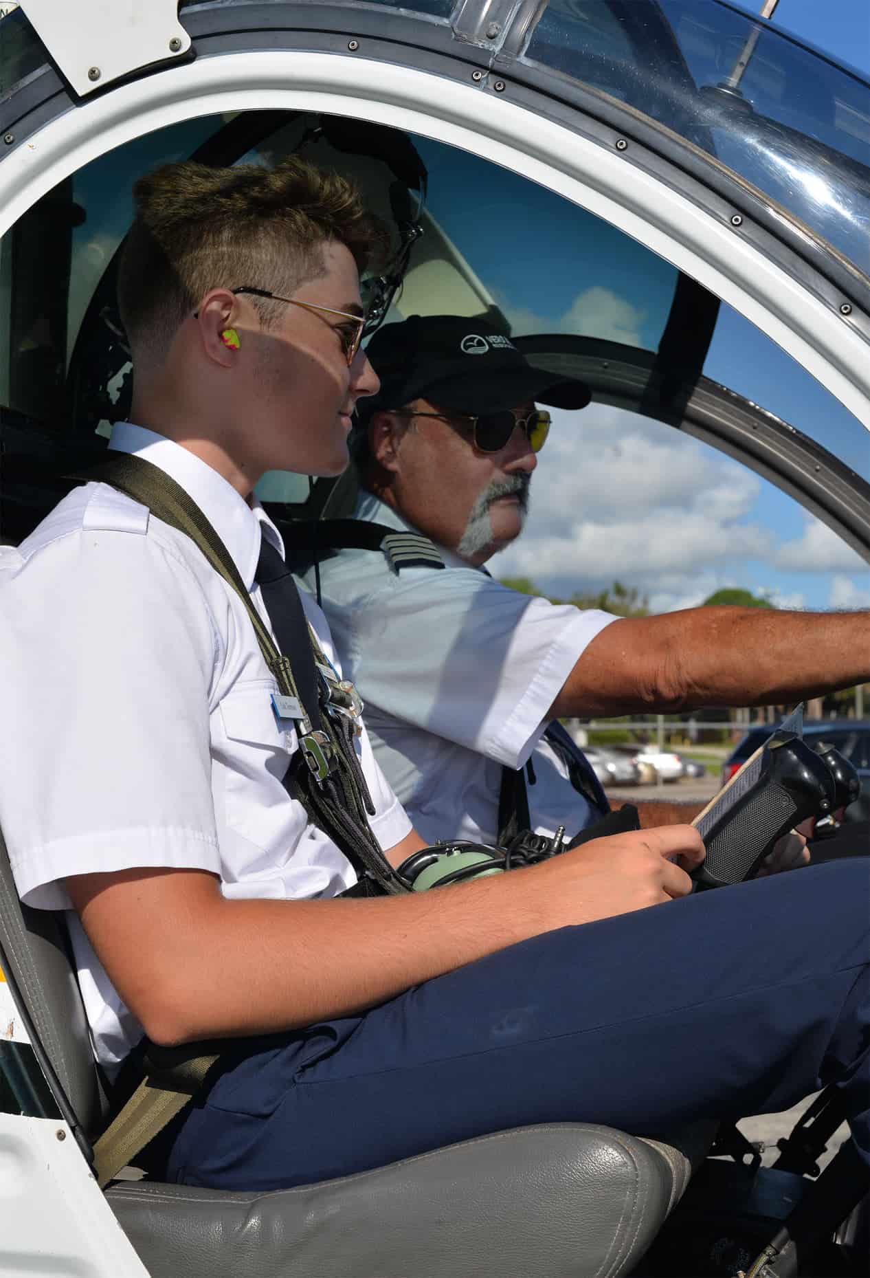 A student receiving instructions in our Schweizer Rotorcraft 269C 1 Heliocopter