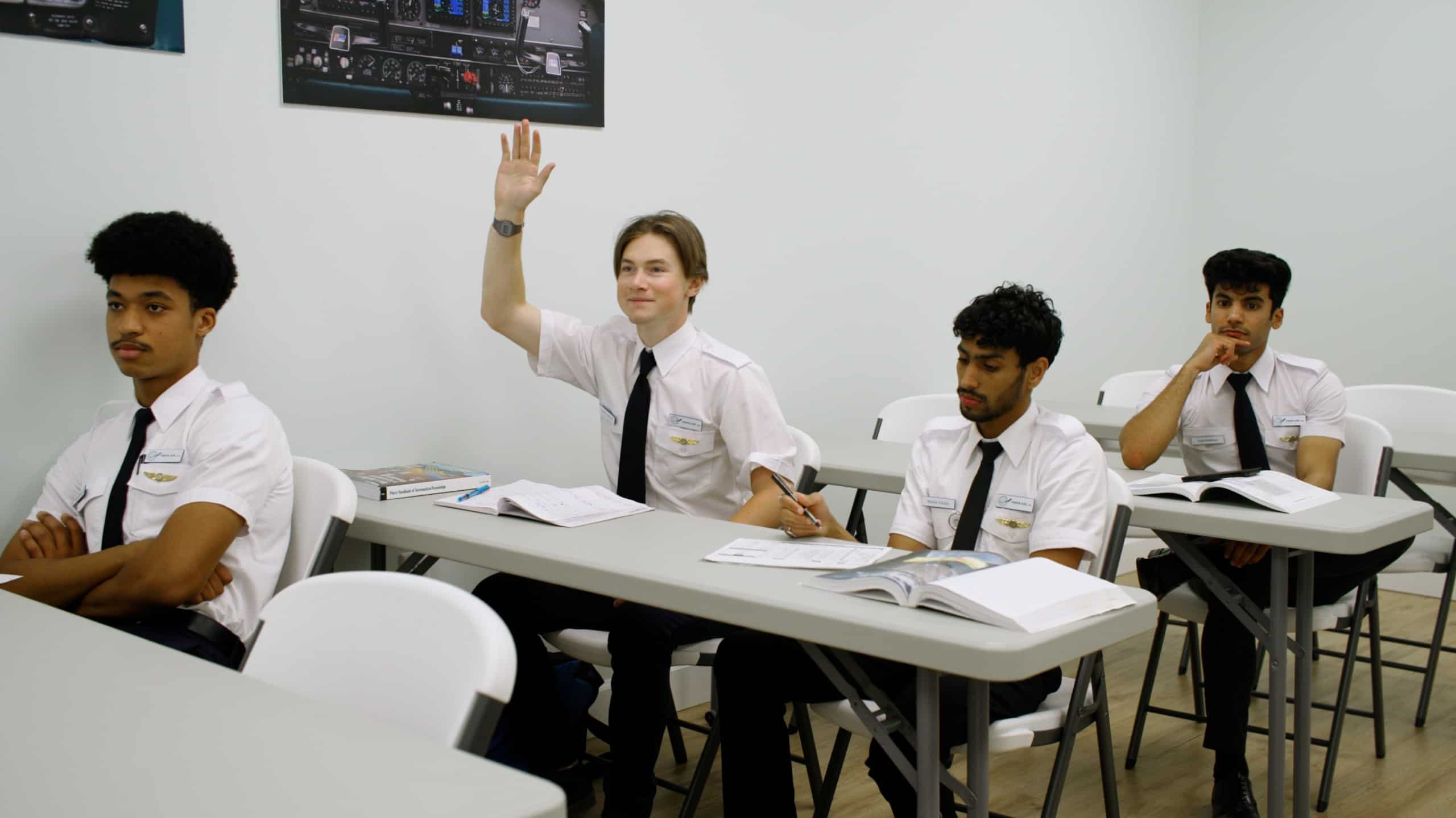 A Paris Air Flight School student raising his hand in a classroom