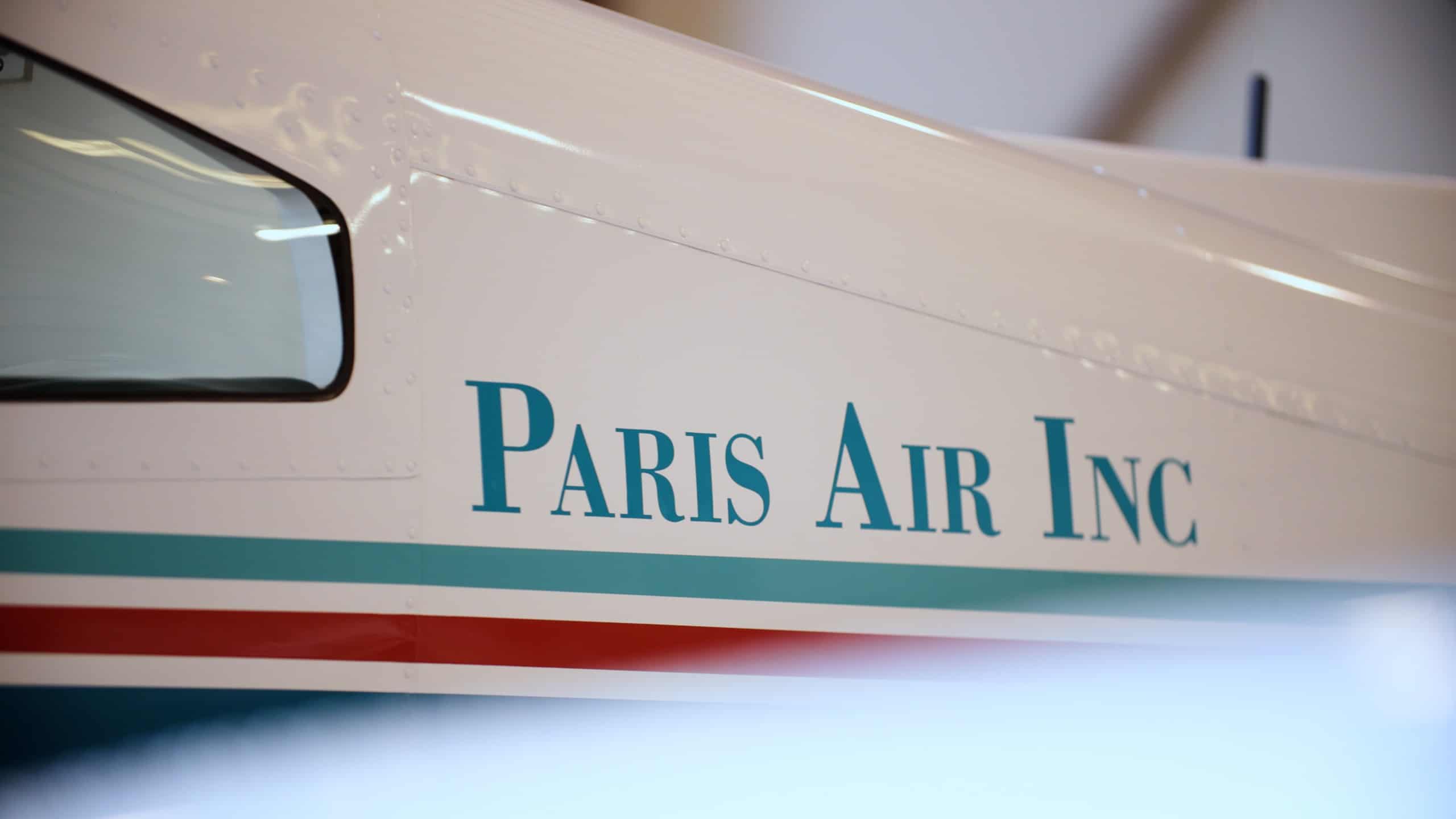 Side of airplane with Paris Air Inc. on the side