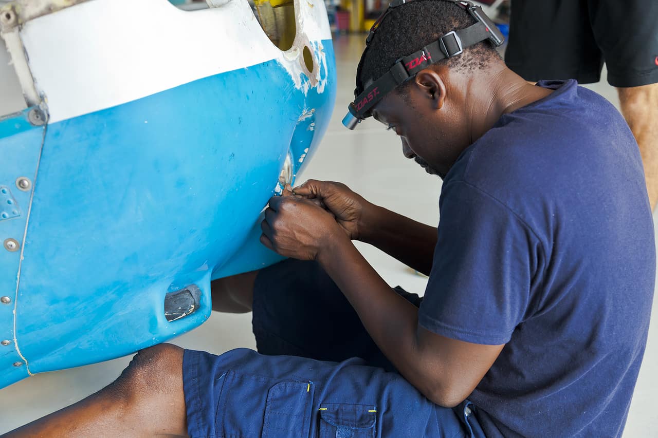 A mechanic working on an airplane