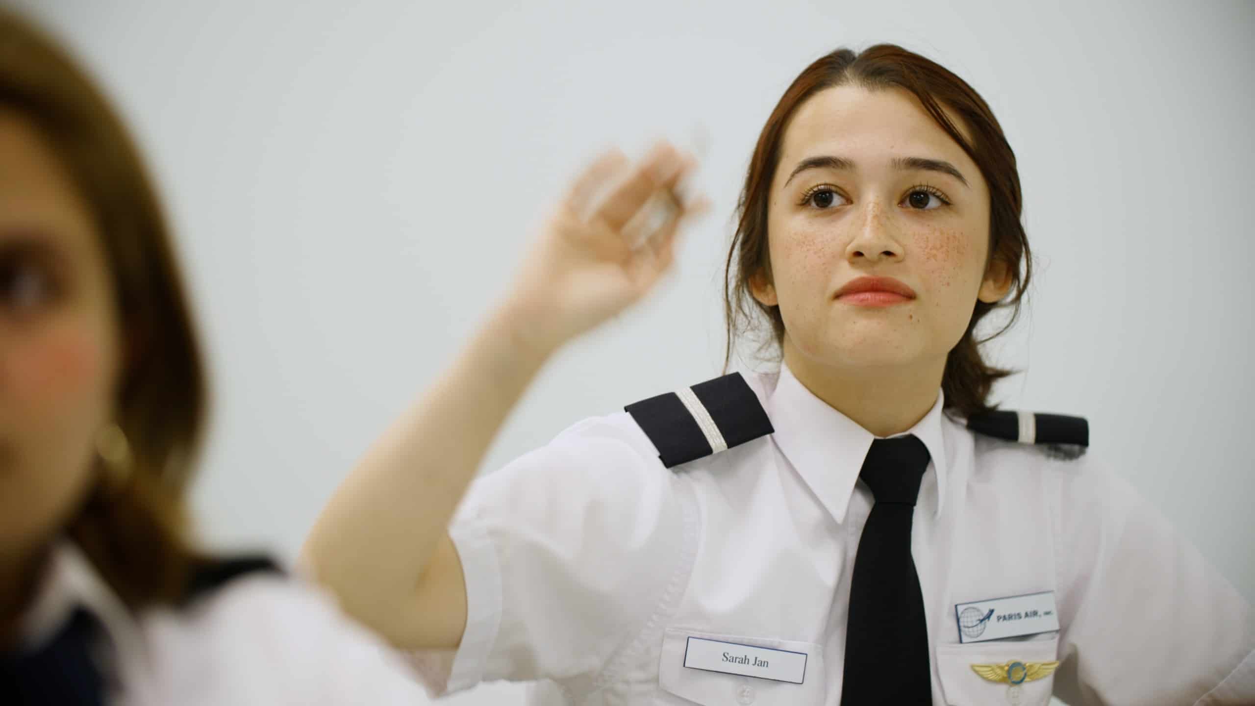 A Paris Air flight student raises her hand
