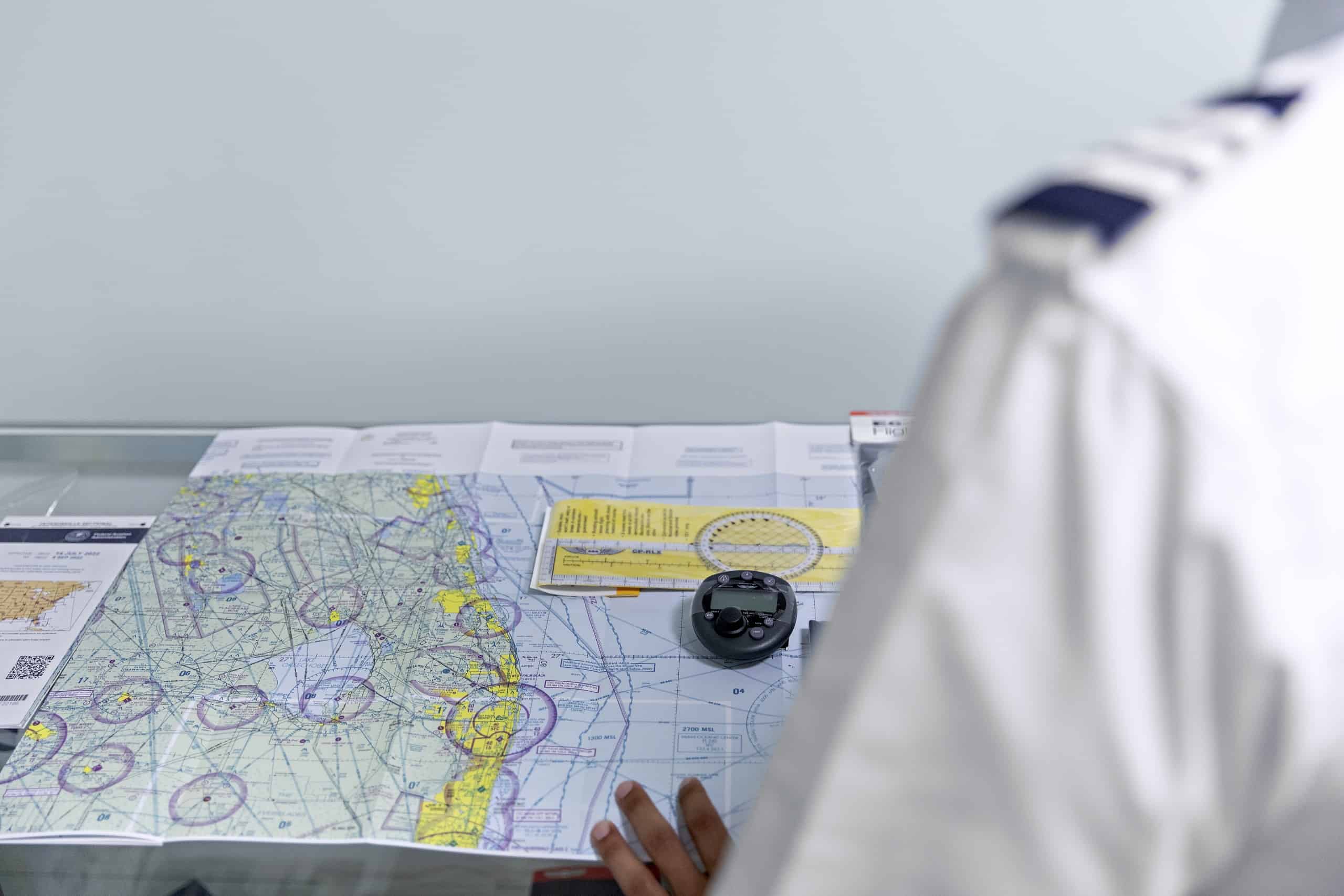 A navigation map and instrument viewed over a pilot's shoulder