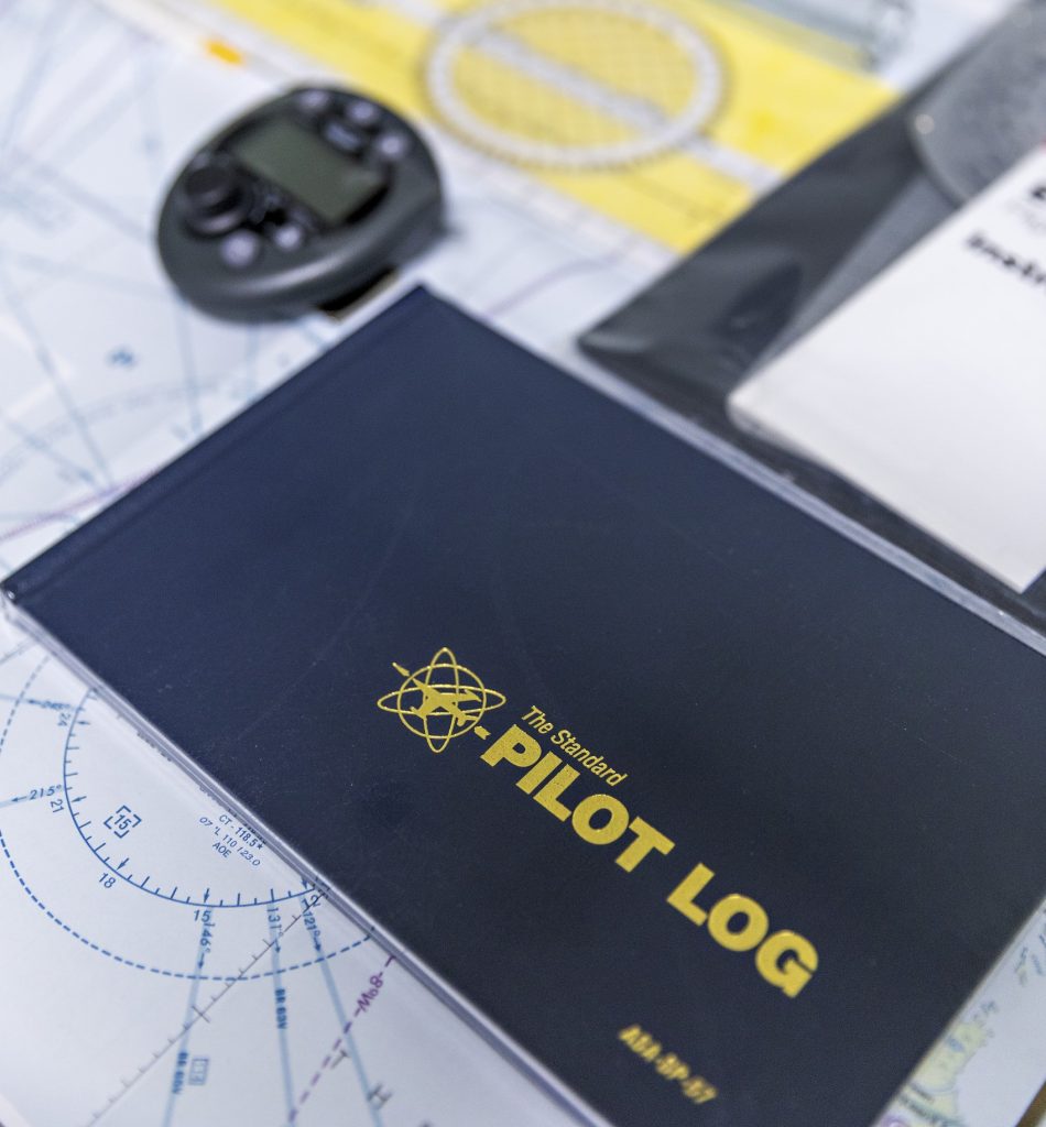 Pilot logbook and instruments on navigation map