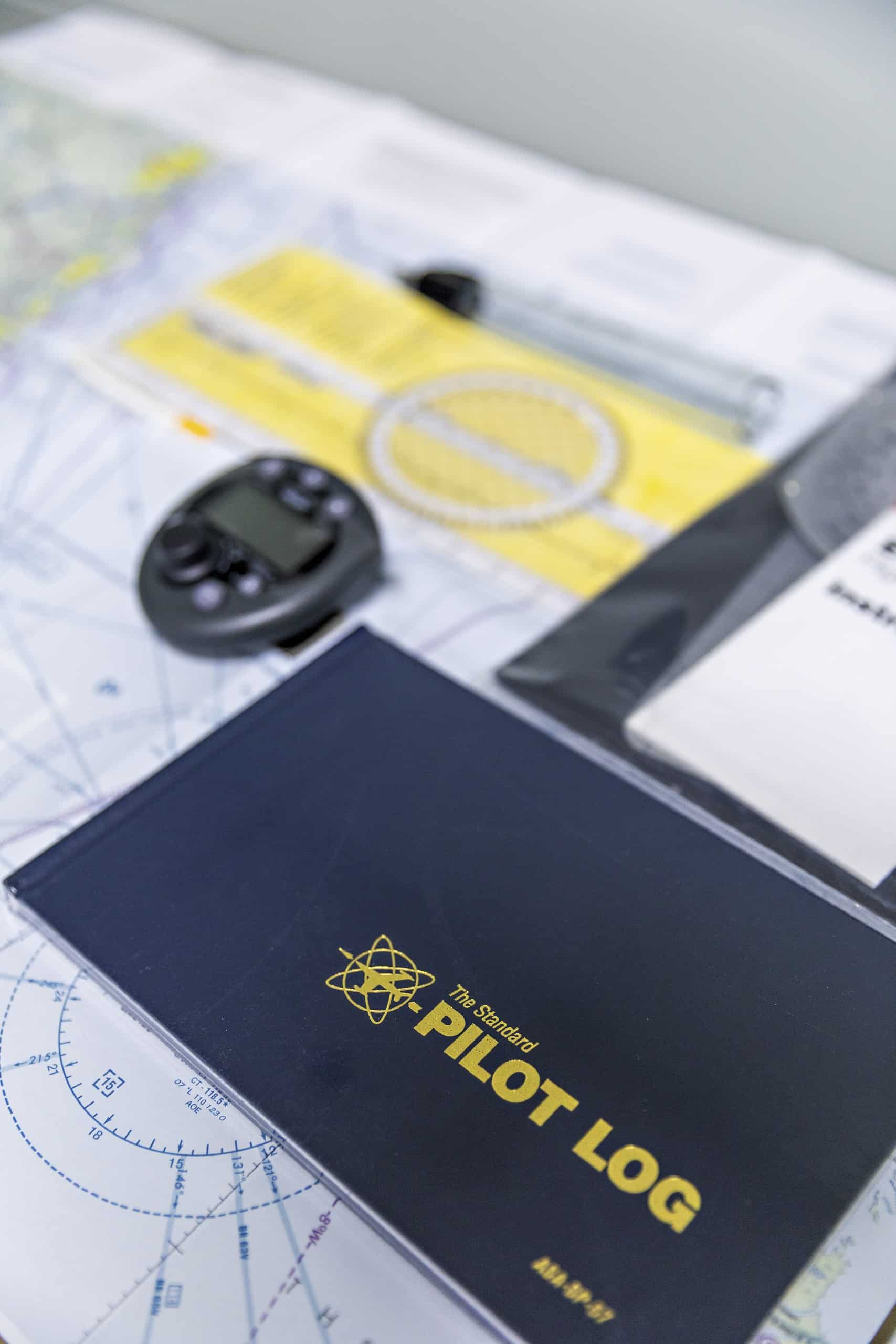 Pilot logbook and instruments on navigation map