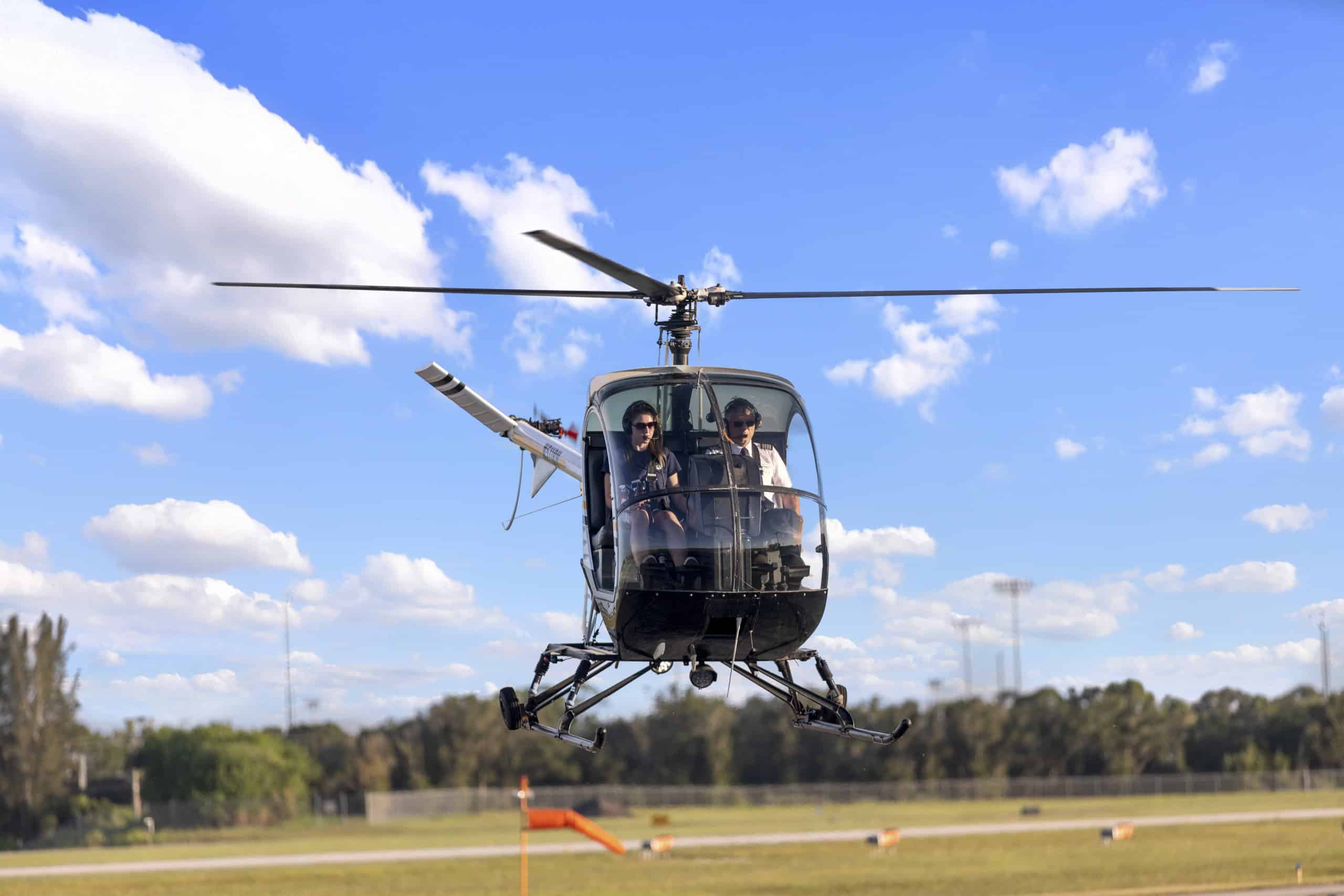 Photo of a helicopter from the front with blue sky and white clouds in the background