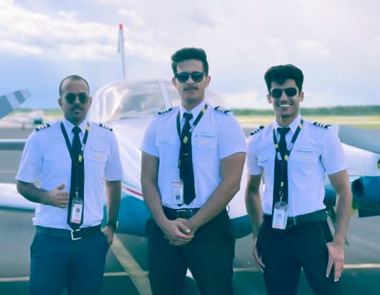 Paris Air flight students standing in front of a small airplane